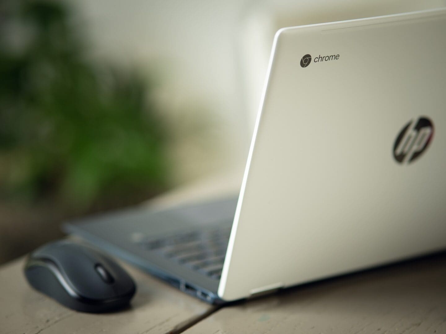 A laptop and mouse sitting on top of a table.