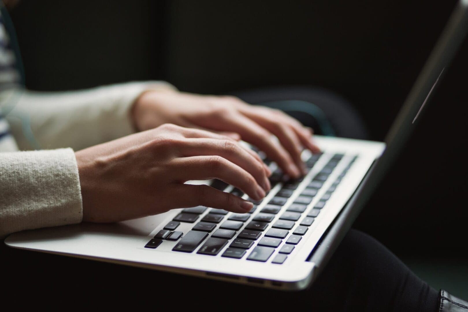 A person typing on a laptop computer.