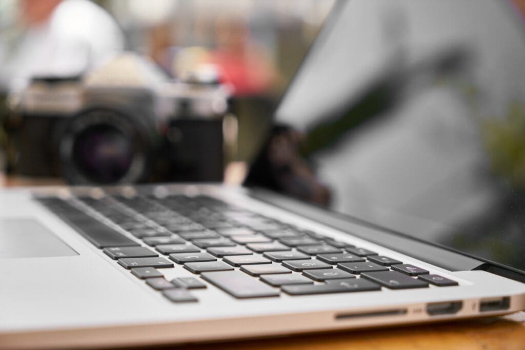 A laptop computer sitting on top of a wooden table.