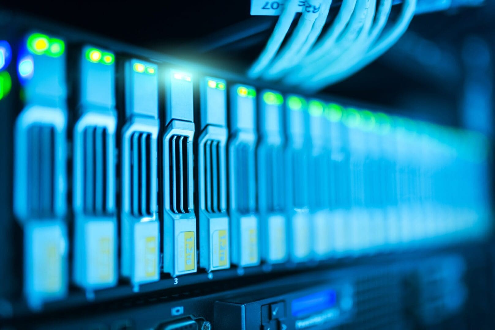 A row of servers in a room with blue lighting.